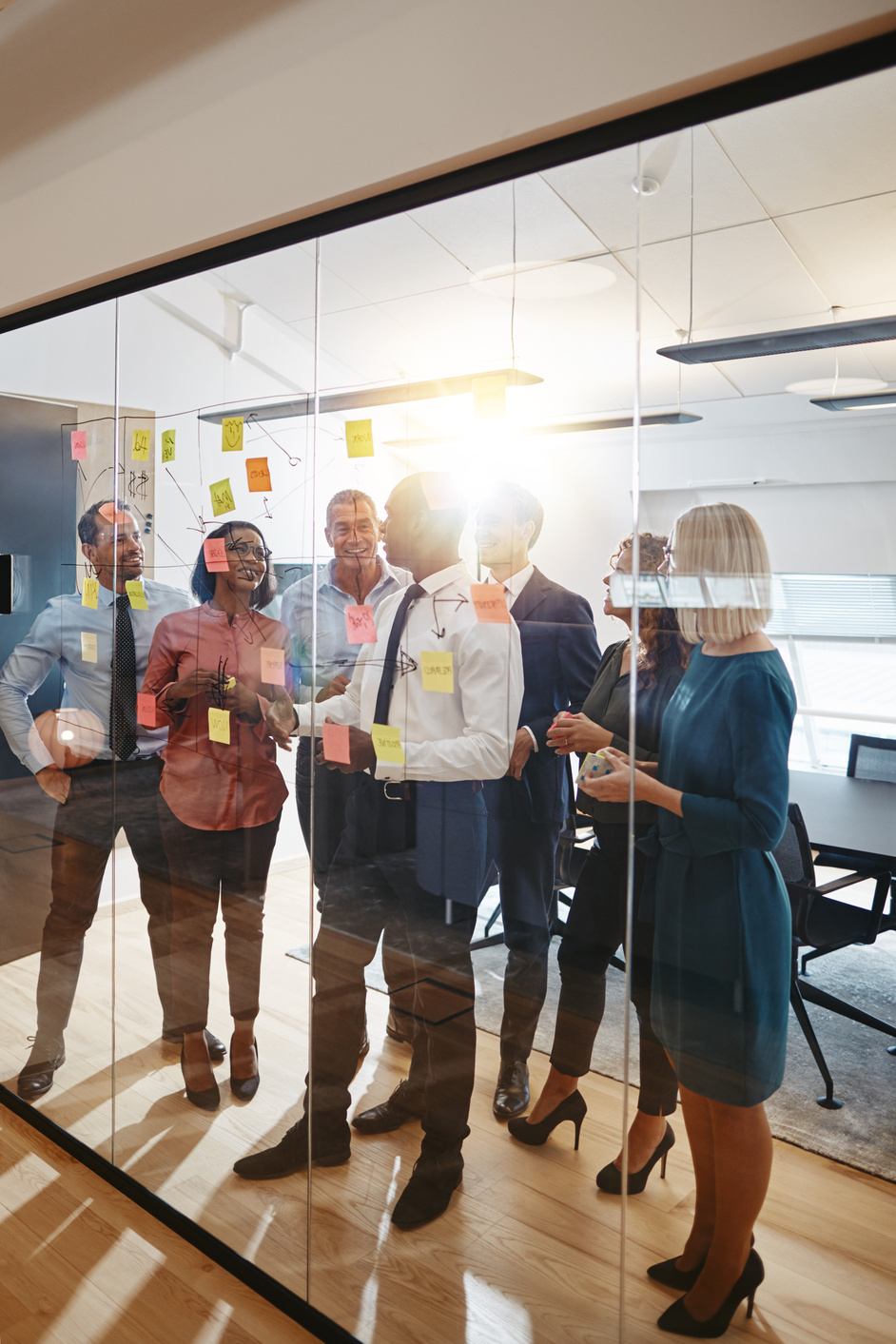 Manager using sticky notes during a team brainstorming session